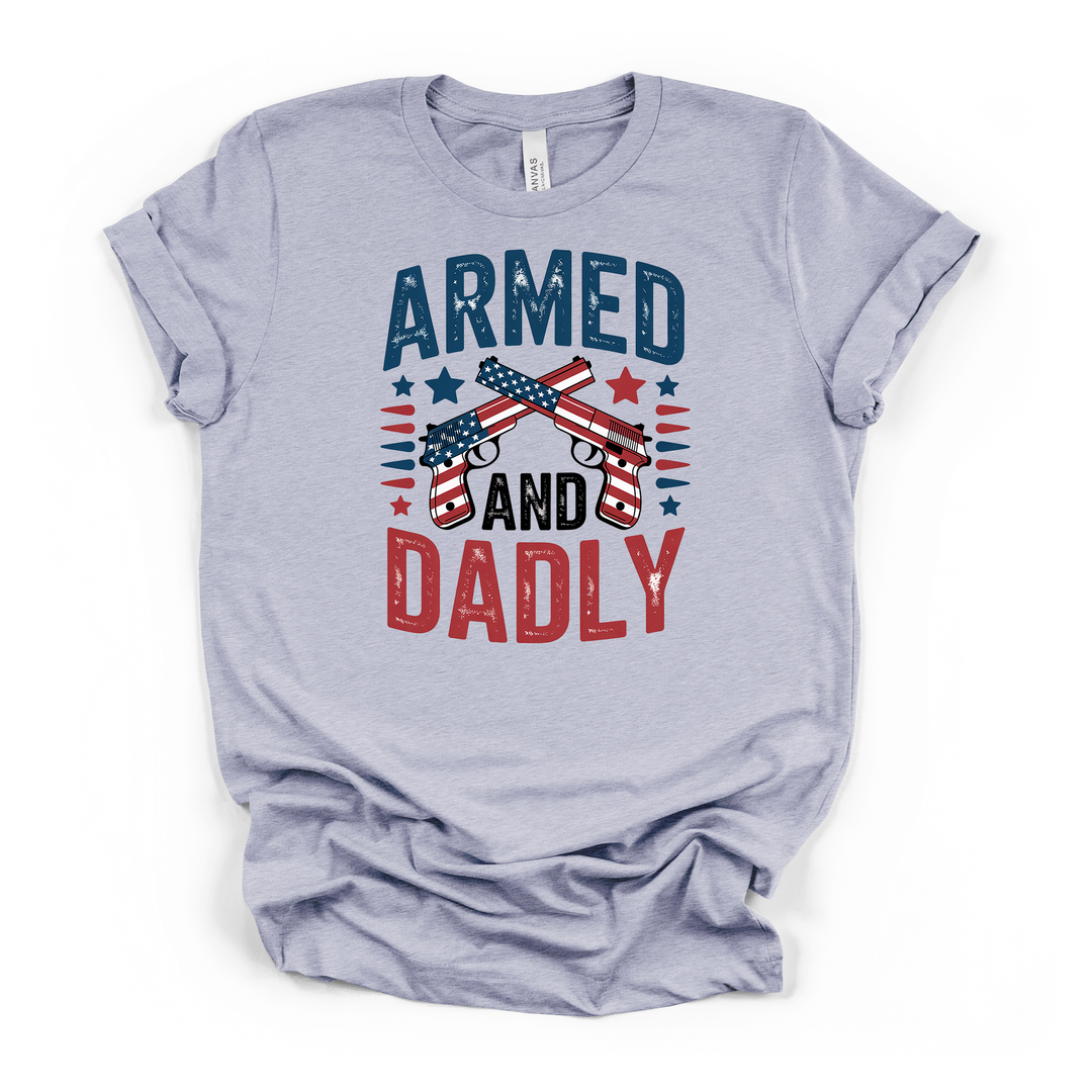 Armed and Dadly funny patriotic dad t-shirt in heather blue with distressed crossed American flag pistols graphic in red white and blue