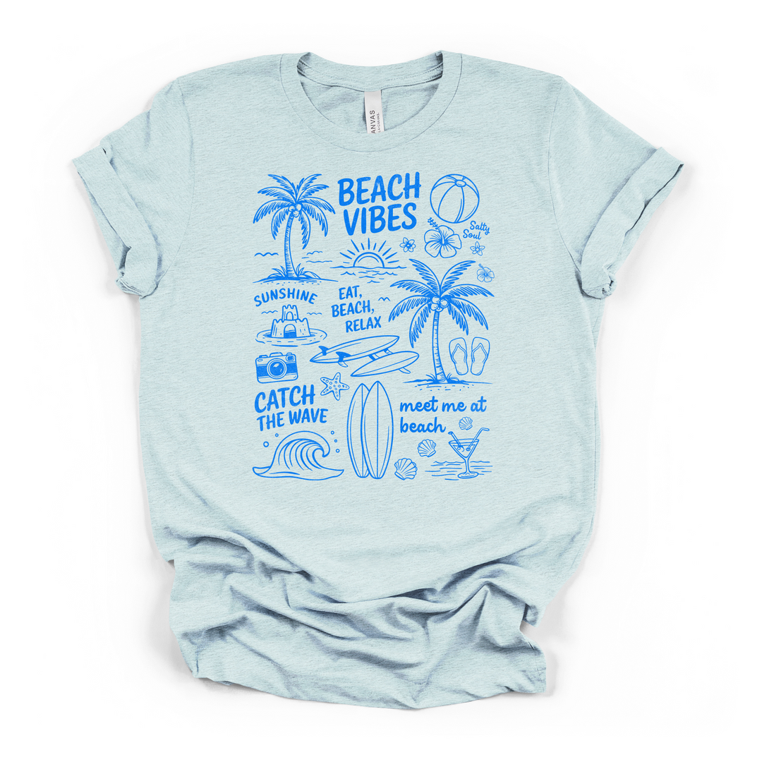 Heather ice blue t-shirt with a blue illustrated Beach Vibes collage graphic with palm trees a surfboard waves hibiscus flowers and beach sayings