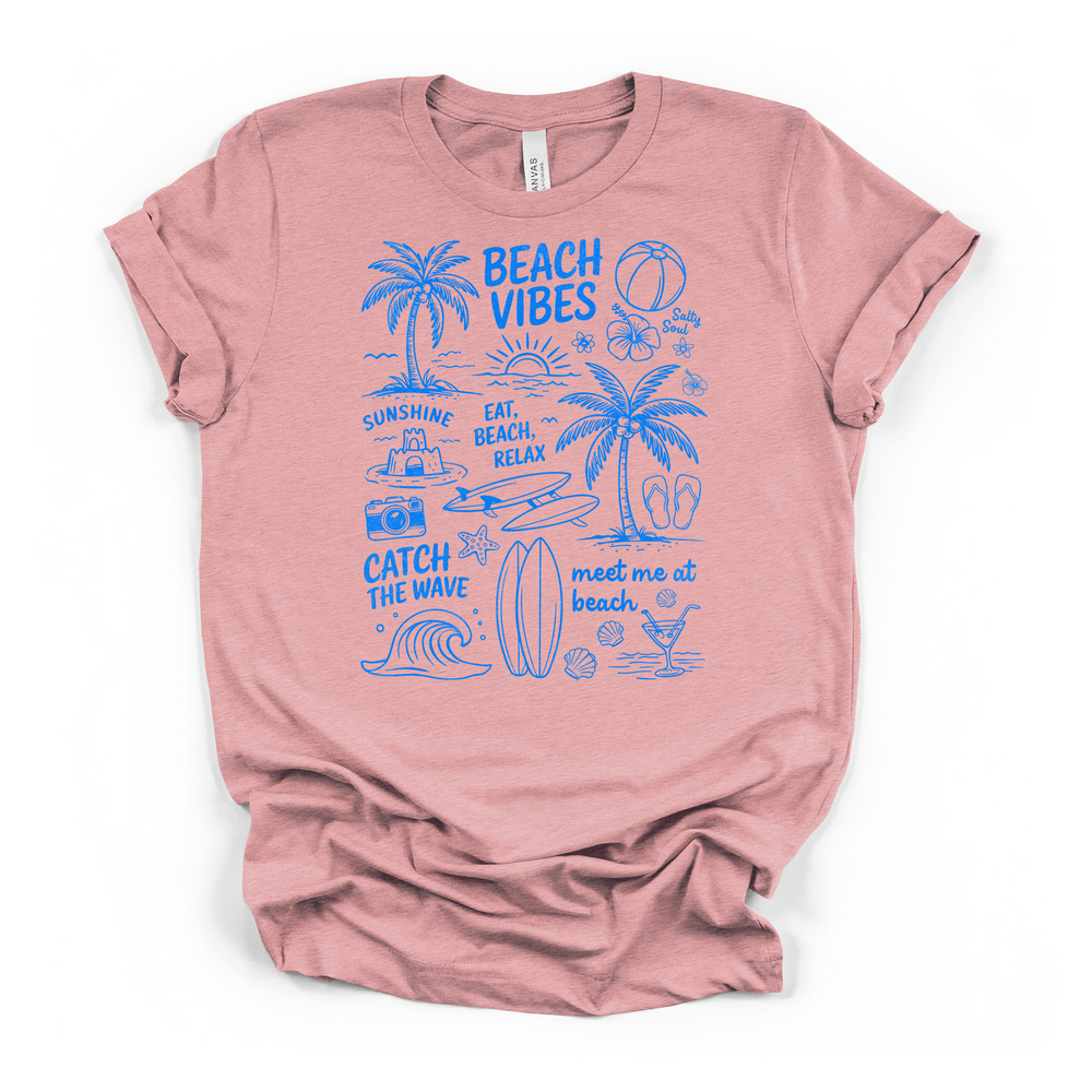 Heather pink t-shirt with a blue doodle Beach Vibes graphic including palm trees ocean waves a surfboard flip flops and fun summer text on the front