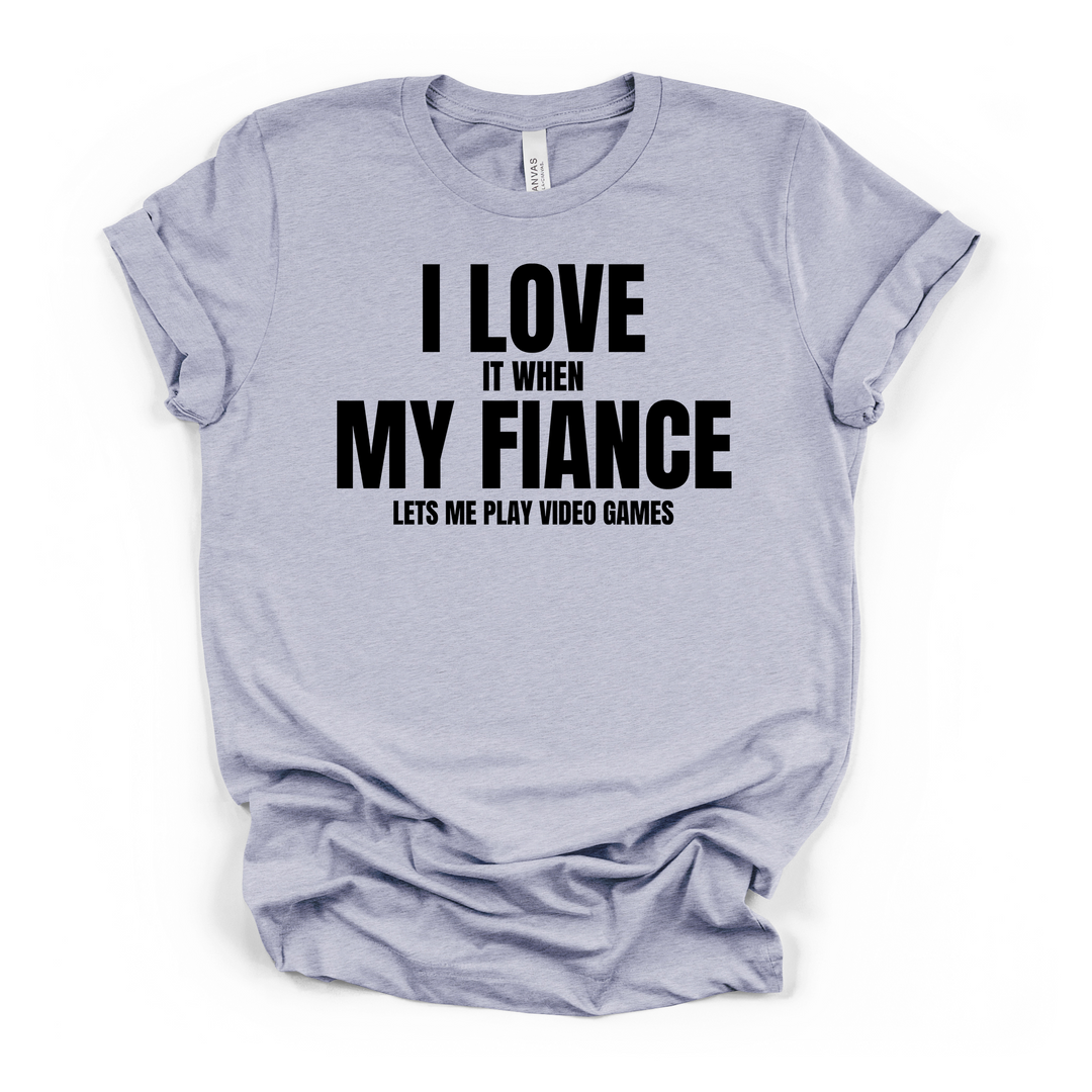 I Love It When My Fiance Lets Me Play Video Games funny gamer t-shirt in heather blue with bold black lettering