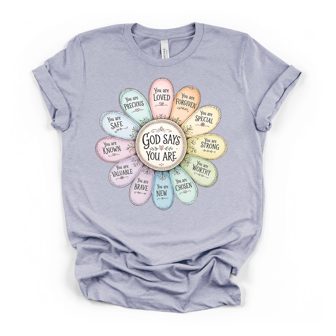 Heather blue t-shirt with a pastel daisy affirmation graphic featuring petals labeled loved forgiven chosen worthy and more with God Says You Are in the center