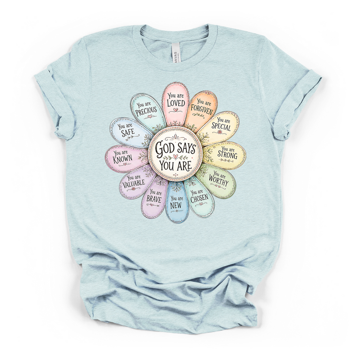 Heather ice blue t-shirt with a soft pastel flower where each petal holds an uplifting faith affirmation and God Says You Are written in the center