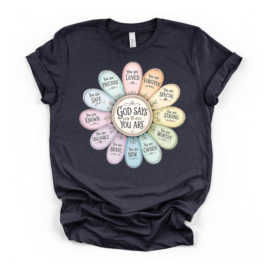 Heather navy t-shirt with a pastel daisy graphic where each petal contains a faith affirmation such as loved chosen worthy and brave with God Says You Are in the center