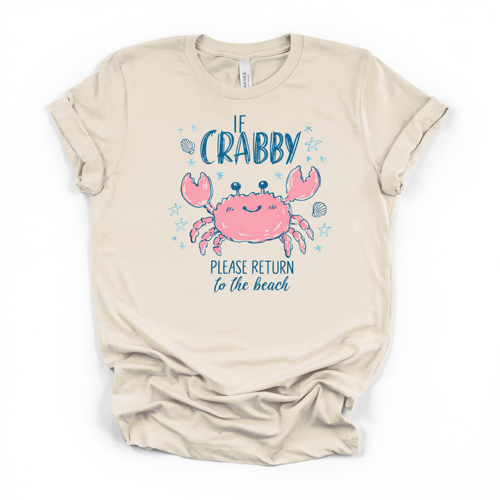 Natural cream t-shirt with a cute illustrated pink crab surrounded by starfish and shells and If Crabby Please Return to the Beach printed in navy blue text