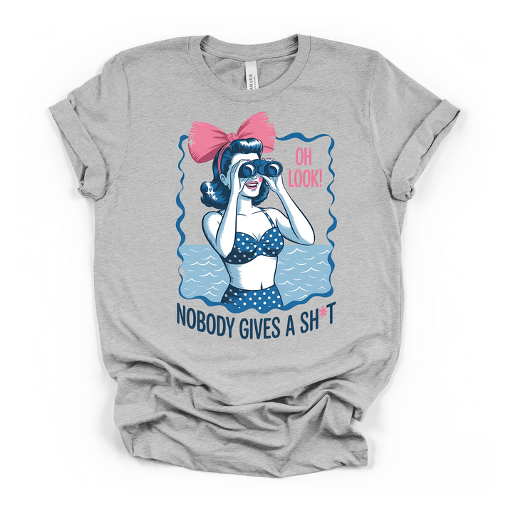Athletic heather t-shirt with a retro pin-up woman in a polka dot swimsuit holding binoculars with Oh Look Nobody Gives a Sht printed on the front