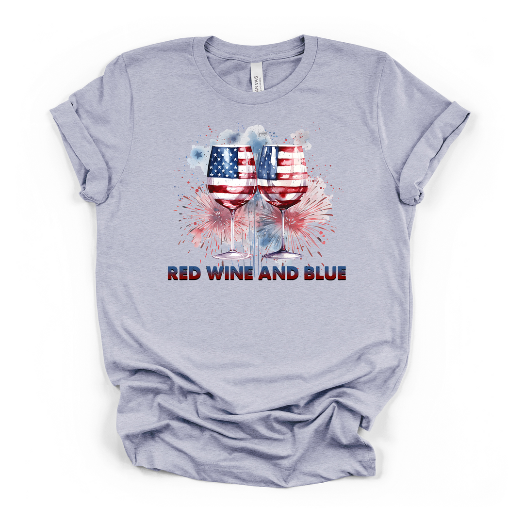 Heather blue t-shirt with patriotic American flag wine glasses and watercolor fireworks graphic and Red Wine and Blue text on the front