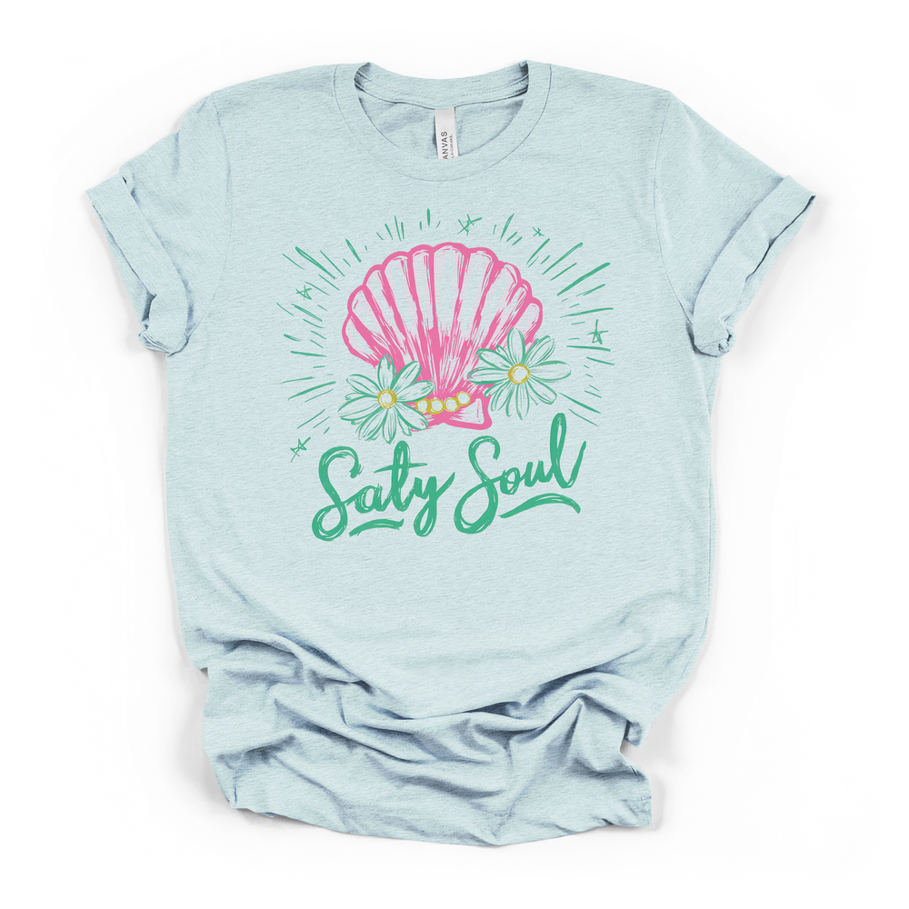 Alt Text: Salty Soul seashell graphic t-shirt in heather ice blue, featuring pink shell, daisies, and teal script lettering