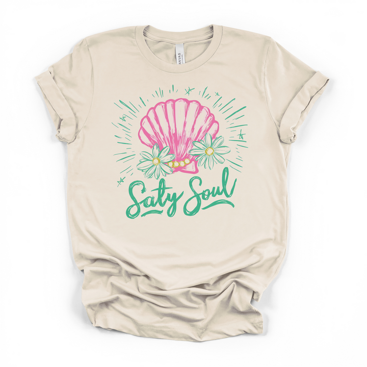 Salty Soul seashell graphic t-shirt in natural, featuring pink shell, daisies, and teal script lettering