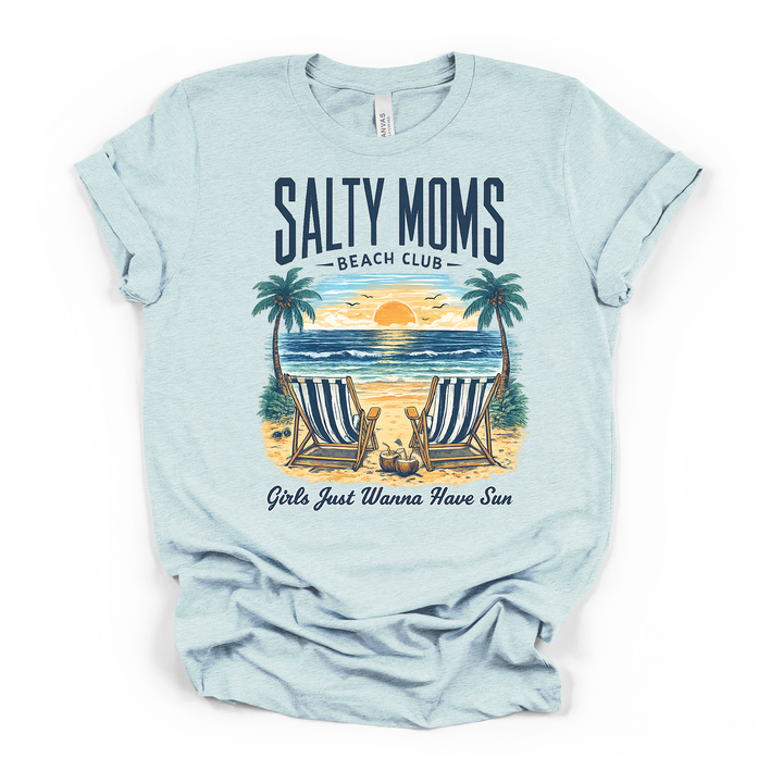 Heather ice blue t-shirt featuring a tropical beach scene with two beach chairs palm trees and coconut drinks with Salty Moms Beach Club text on the front