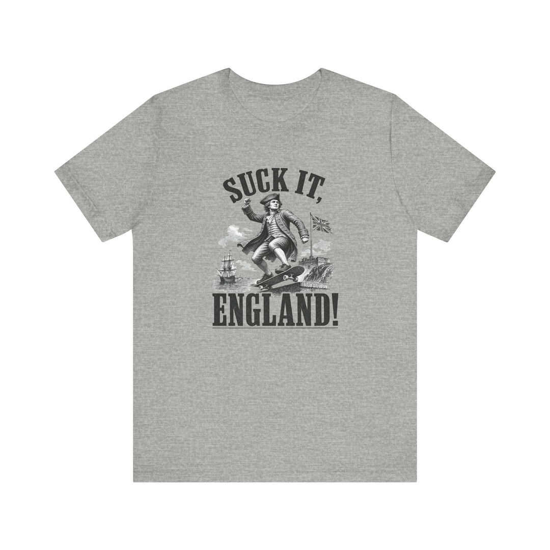 Gray t-shirt with vintage colonial soldier skateboarding graphic and bold text reading Suck It England