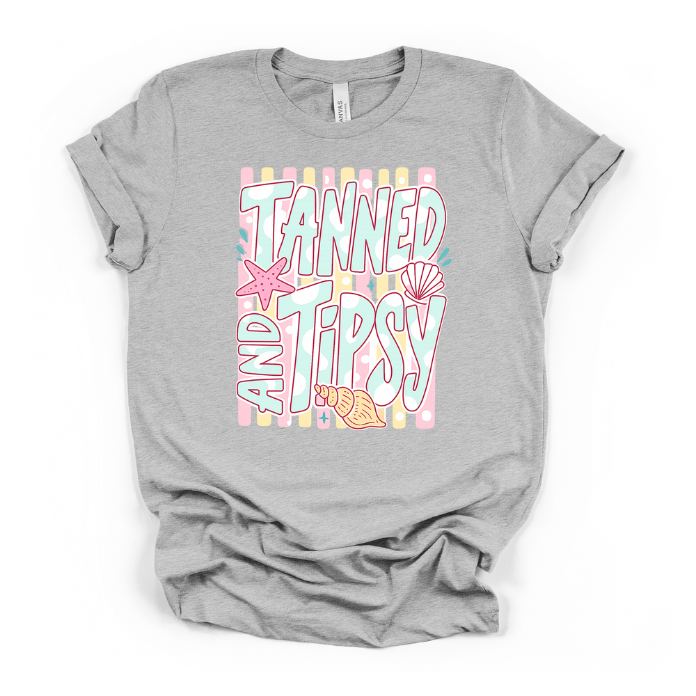 Athletic heather t-shirt with a pastel striped Tanned and Tipsy beach graphic featuring retro lettering a starfish and seashells on the front