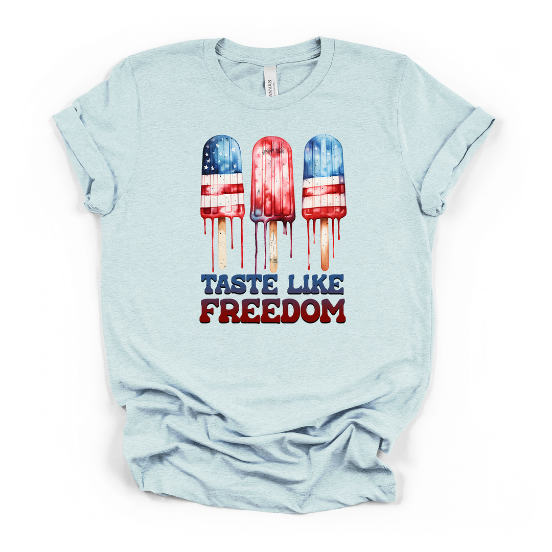 Heather ice blue t-shirt with three melting red white and blue patriotic popsicles graphic and Taste Like Freedom text on the front