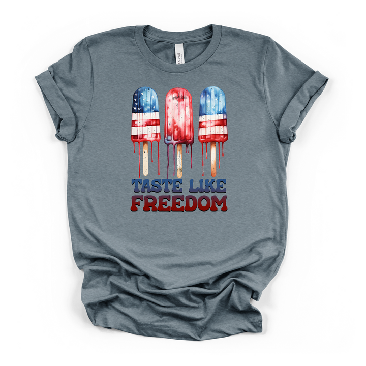 Heather slate t-shirt with three dripping red white and blue American flag popsicles and Taste Like Freedom text printed on the front