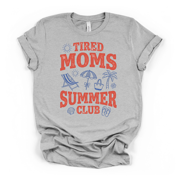 Athletic heather t-shirt with bold red retro Tired Moms Summer Club text surrounded by blue beach icons including a chair umbrella and palm tree