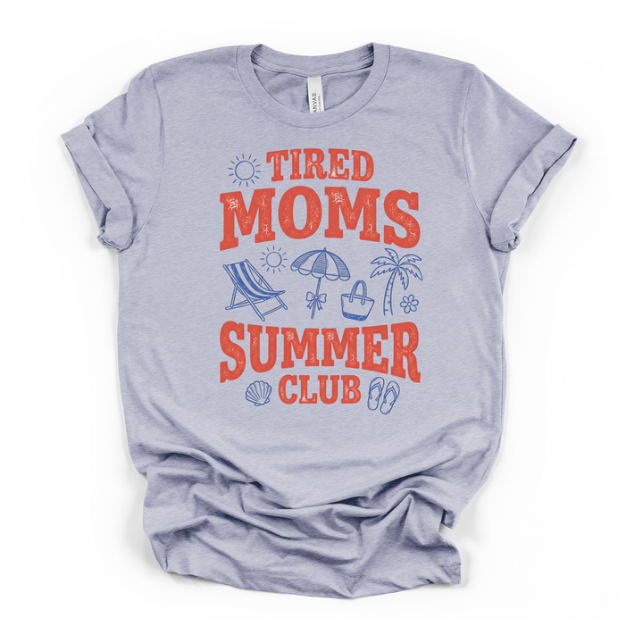 Heather blue t-shirt featuring distressed red Tired Moms Summer Club lettering with blue beach illustrations including flip flops a shell and palm tree