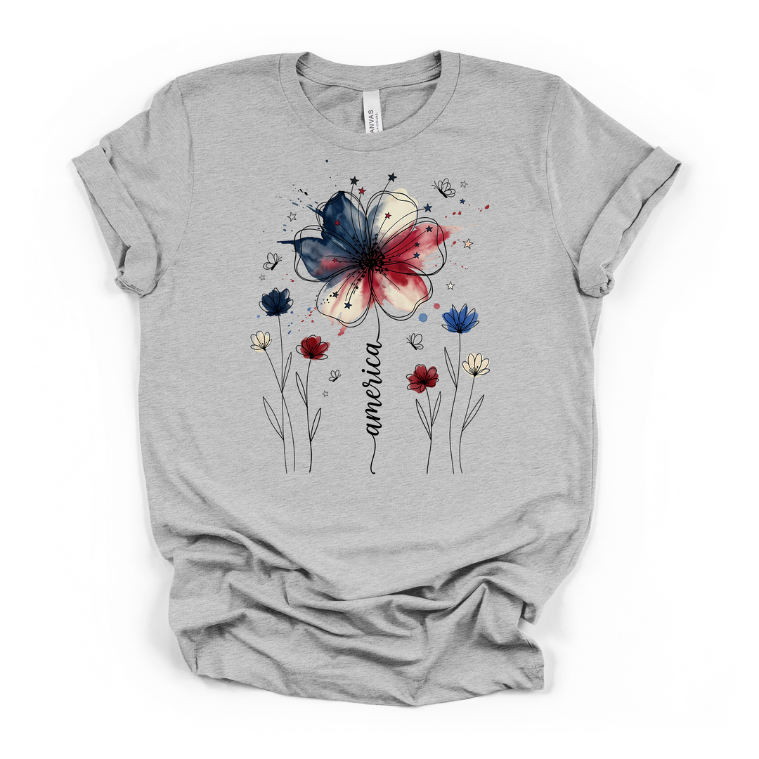 Athletic heather t-shirt with a red white and blue watercolor wildflower surrounded by line-art blooms stars and butterflies with America in script along the stem