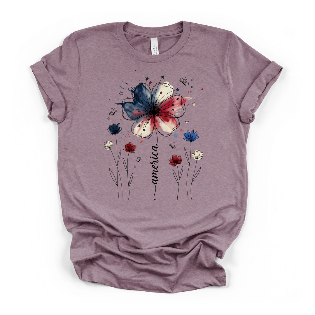 Heather purple t-shirt with a beautiful red white and blue watercolor wildflower graphic with line-art flowers butterflies and America script on the stem