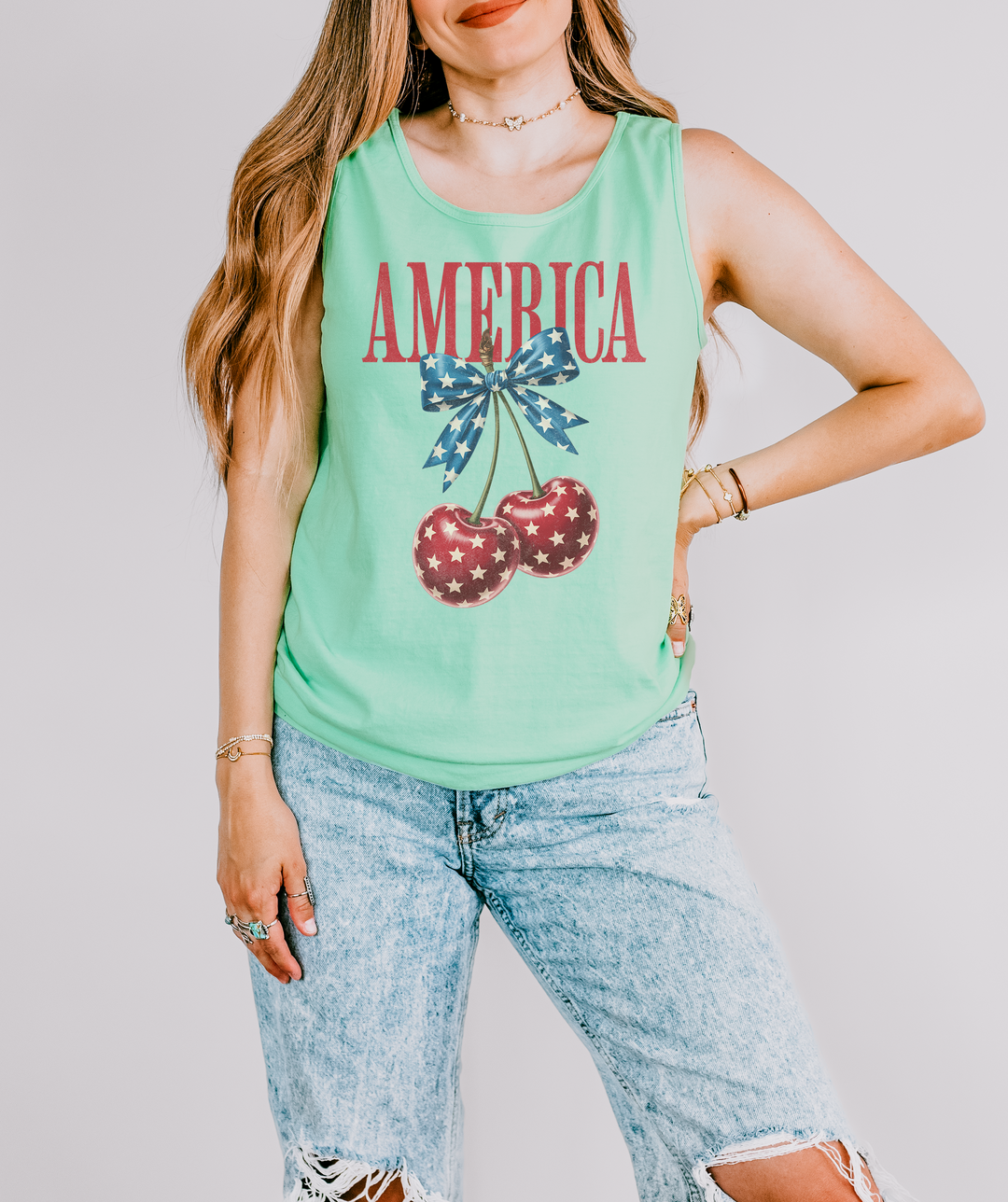 America Cherry Bow patriotic tank top in Island Reef with red America text, star-print cherries, and a stars and stripes bow