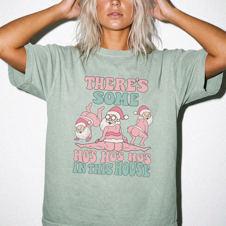 Theres Some Ho Ho Hos in This House funny Christmas shirt in Bay green with three dancing retro Santas and pink and teal retro text
