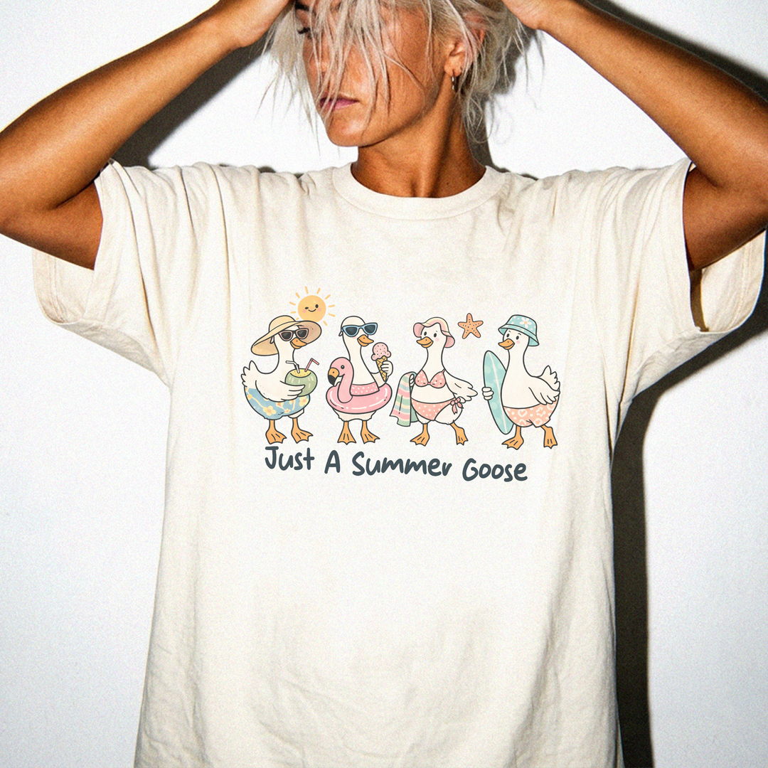 Just a Summer Goose graphic tee in Ivory with four beach-dressed geese and the text Just A Summer Goose