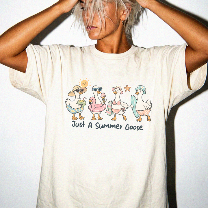 Just a Summer Goose graphic tee in Ivory with four beach-dressed geese and the text Just A Summer Goose