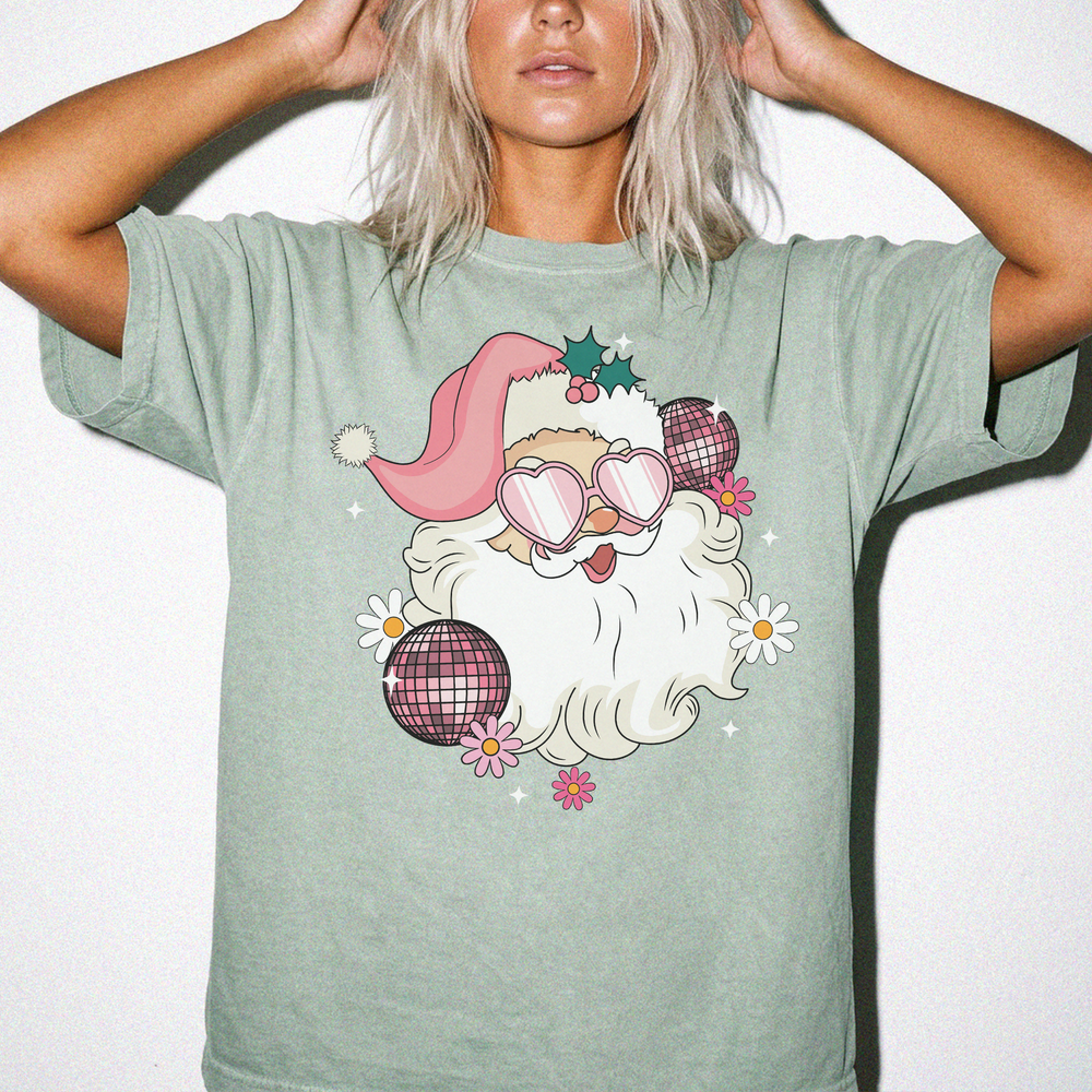 Retro Disco Santa Christmas shirt in Bay green with a groovy Santa wearing heart sunglasses surrounded by disco balls and daisies