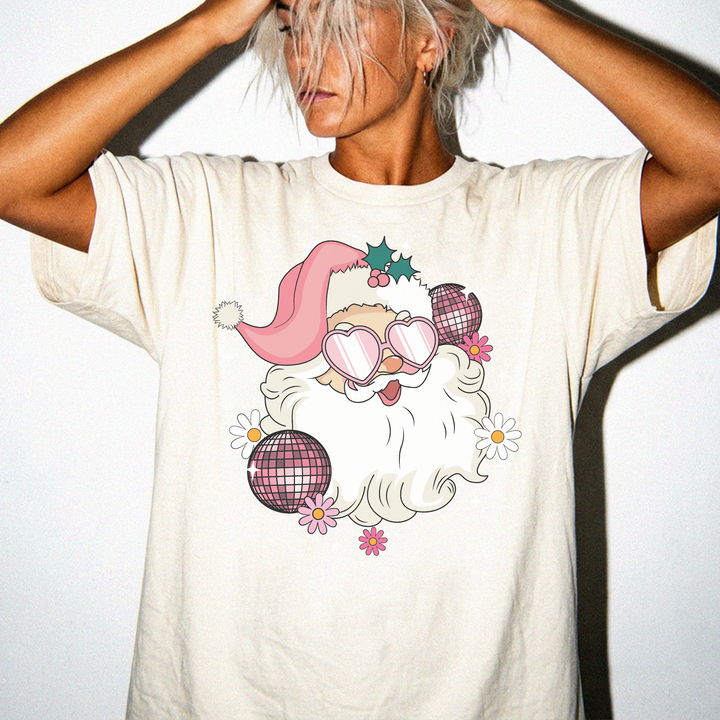 Retro Disco Santa Christmas shirt in Ivory with a groovy Santa wearing heart sunglasses surrounded by disco balls and daisies