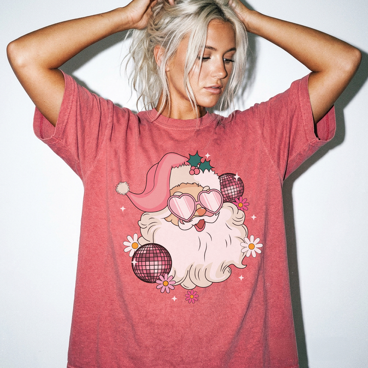 Retro Disco Santa Christmas shirt in Watermelon red with a groovy Santa wearing heart sunglasses surrounded by disco balls and daisies