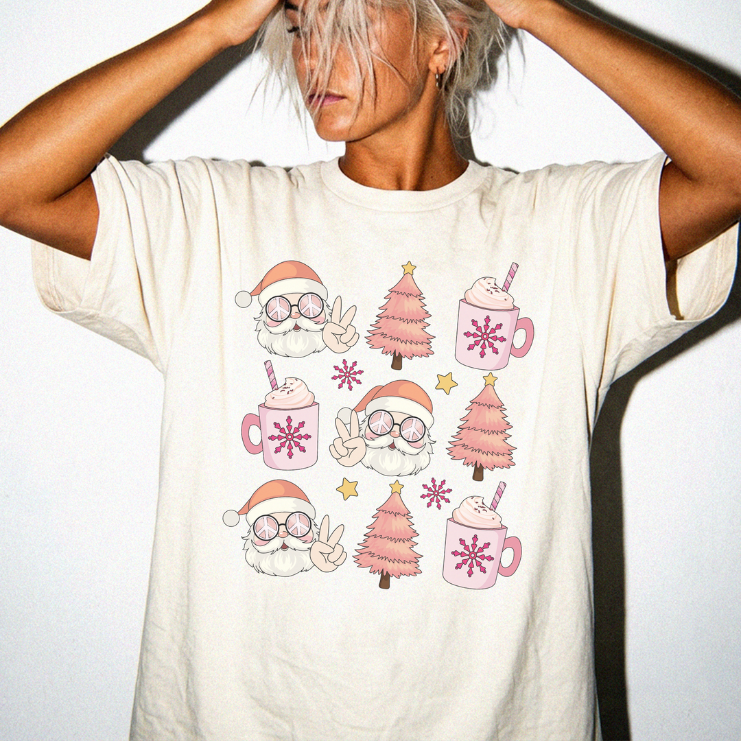 Retro Santa Cocoa Christmas shirt in Ivory featuring groovy Santas, pink Christmas trees, cocoa mugs, and snowflakes